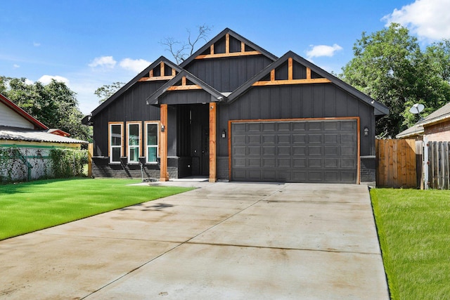 3813 Galvez Ave, Fort Worth, TX 76111 - view of front of home with driveway, an attached garage, and board and batten siding