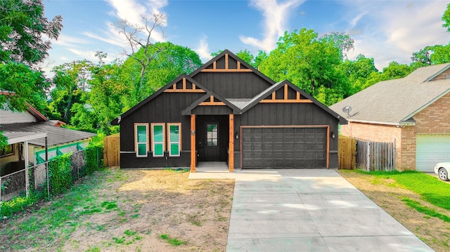 3813 Galvez Ave, Fort Worth, TX 76111 - view of front of property with an attached garage, concrete driveway, and board and batten siding