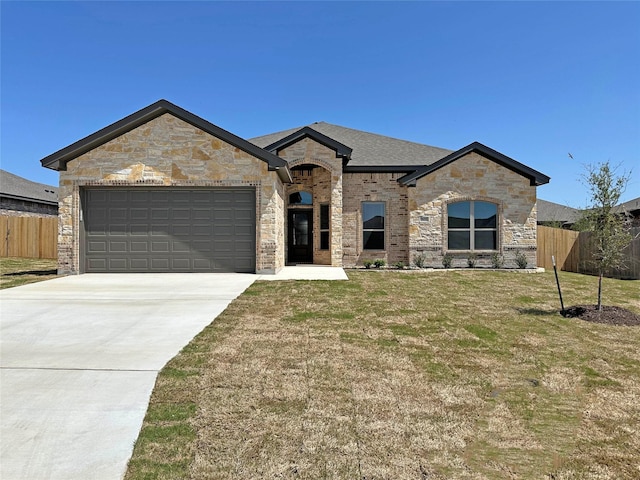507 Magnolia Dr, Troy, TX 76579 - french country home featuring an attached garage, concrete driveway, stone siding, brick siding, and roof with shingles