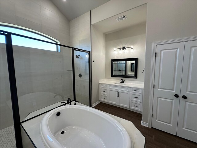 507 Magnolia Dr, Troy, TX 76579 - bathroom featuring a garden tub, vanity, a stall shower, wood finished floors, and lofted ceiling