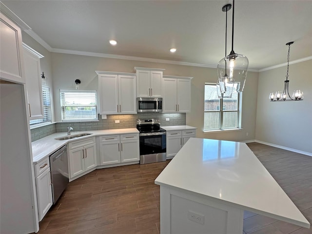 507 Magnolia Dr, Troy, TX 76579 - kitchen featuring stainless steel appliances, a sink, dark wood-style floors, white cabinetry, and backsplash