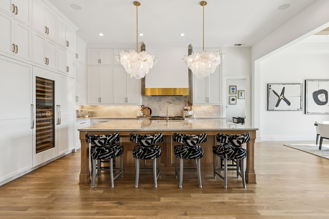 4309 American Pharoah Way, Celina, TX 75009 - kitchen with a chandelier, wine cooler, light countertops, light wood finished floors, and recessed lighting