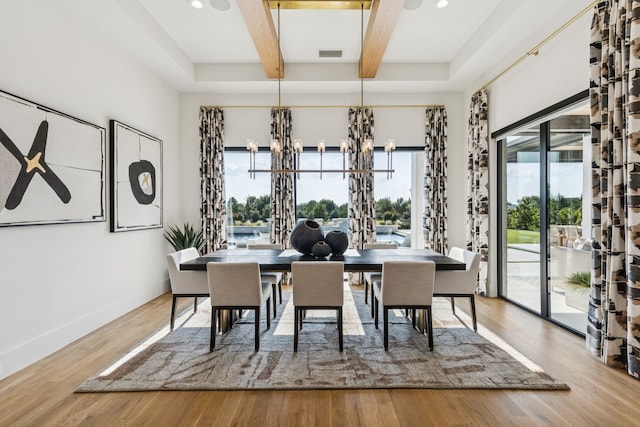 4309 American Pharoah Way, Celina, TX 75009 - dining space featuring a chandelier, beam ceiling, healthy amount of natural light, baseboards, and wood finished floors