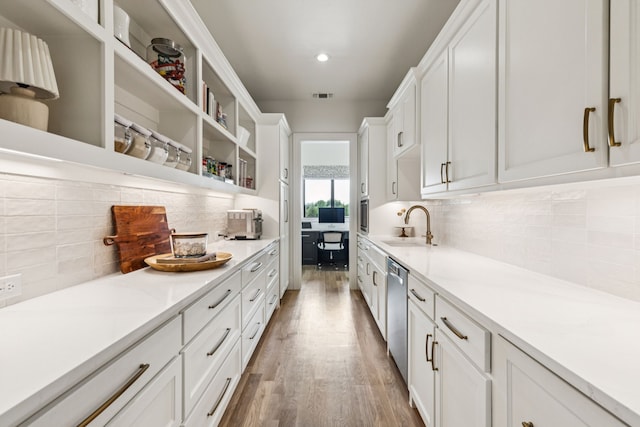 4309 American Pharoah Way, Celina, TX 75009 - kitchen with stainless steel dishwasher, a sink, white cabinetry, open shelves, and wood finished floors