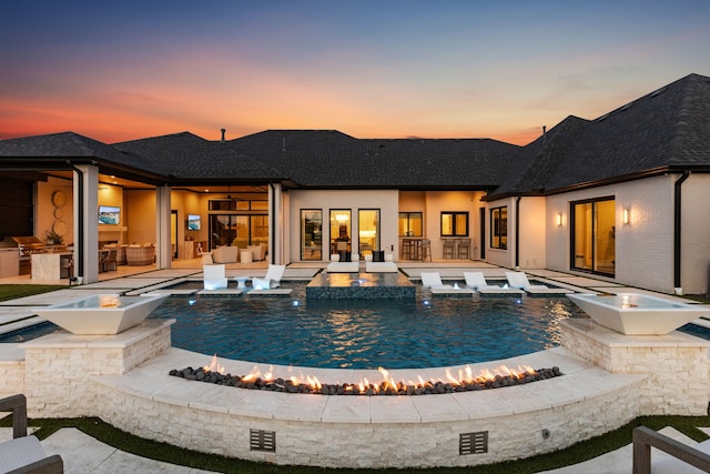 4309 American Pharoah Way, Celina, TX 75009 - rear view of house with area for grilling, a patio area, a pool with connected hot tub, and a shingled roof