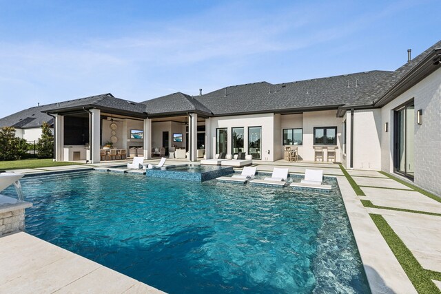 4309 American Pharoah Way, Celina, TX 75009 - back of property at dusk featuring an outdoor kitchen, a yard, a patio, ceiling fan, and stucco siding