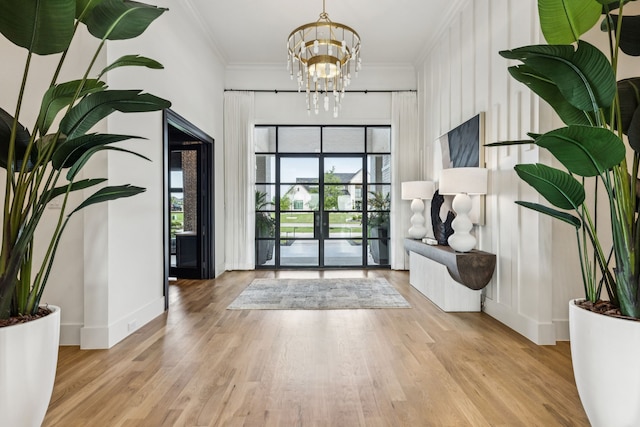 4309 American Pharoah Way, Celina, TX 75009 - entrance foyer featuring a chandelier, wood finished floors, ornamental molding, and baseboards