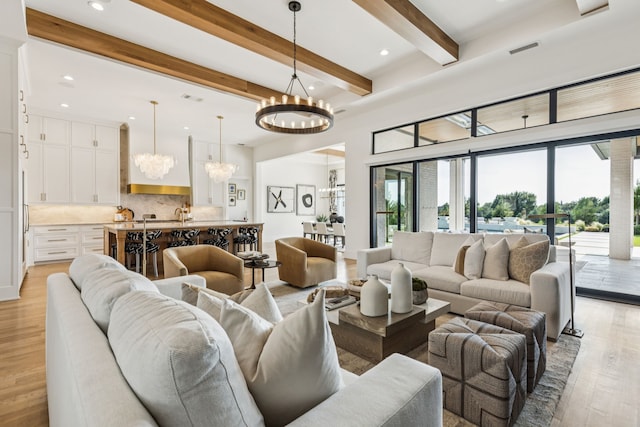 4309 American Pharoah Way, Celina, TX 75009 - living room with a chandelier, light wood-style floors, beamed ceiling, and recessed lighting