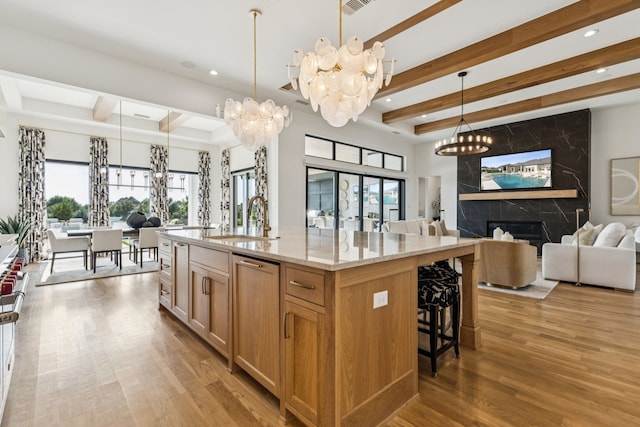 4309 American Pharoah Way, Celina, TX 75009 - kitchen featuring open floor plan, beam ceiling, a chandelier, a sink, and plenty of natural light