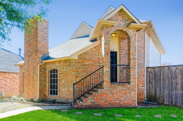 2229 Silverthorn Ln, Flower Mound, TX 75028 - view of front of house featuring brick siding, a chimney, and a shingled roof