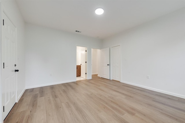 1113 Verbena St, Fort Worth, TX 76104 - unfurnished bedroom with light wood-style floors, baseboards, and ensuite bath