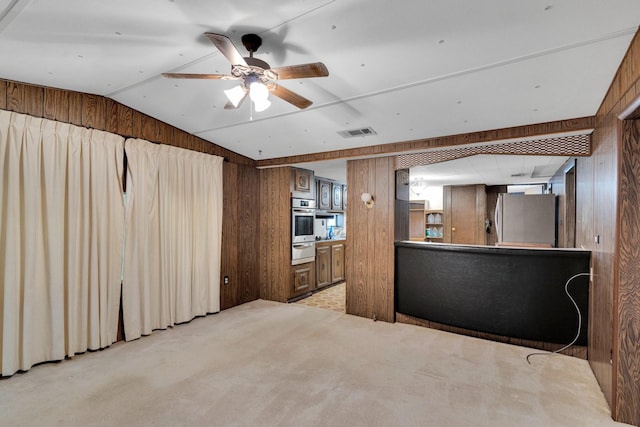 933 El Camino Rd, Waxahachie, TX 75167 - living area with wooden walls, a ceiling fan, lofted ceiling, and light carpet