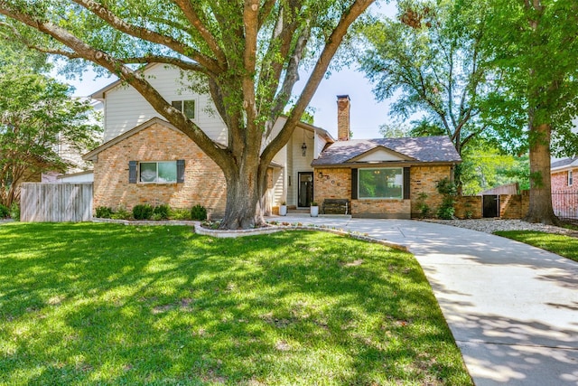 606 Kirby Ln, Richardson, TX 75080 - view of front of house featuring brick siding and a chimney