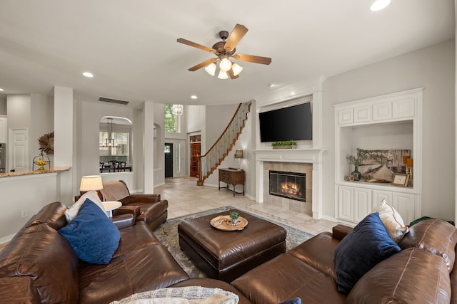 4013 Tulane St, Flower Mound, TX 75022 - living area featuring a tiled fireplace, recessed lighting, ceiling fan, arched walkways, and baseboards