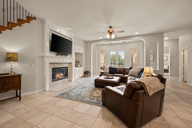 4013 Tulane St, Flower Mound, TX 75022 - living area featuring recessed lighting, a ceiling fan, light tile patterned floors, arched walkways, and a fireplace