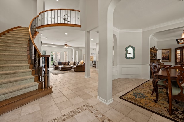 4013 Tulane St, Flower Mound, TX 75022 - foyer with arched walkways, stairway, light tile patterned flooring, ceiling fan, and wainscoting