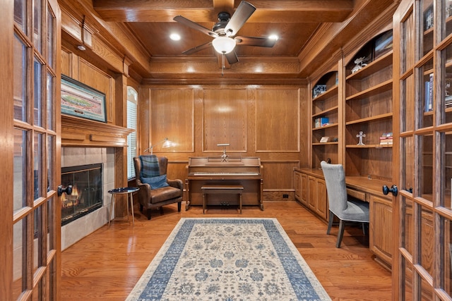 4013 Tulane St, Flower Mound, TX 75022 - home office featuring crown molding, a fireplace, built in study area, wooden walls, and a ceiling fan
