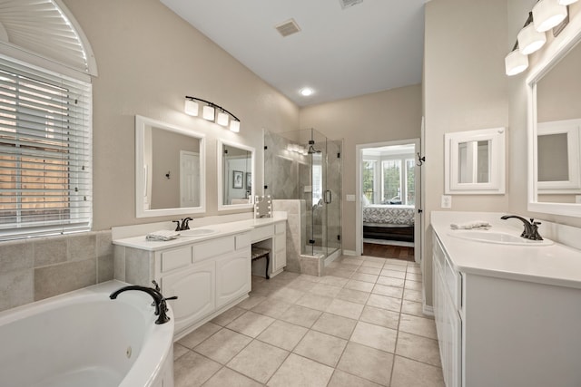 4013 Tulane St, Flower Mound, TX 75022 - bathroom featuring a stall shower, two vanities, a whirlpool tub, and tile patterned flooring