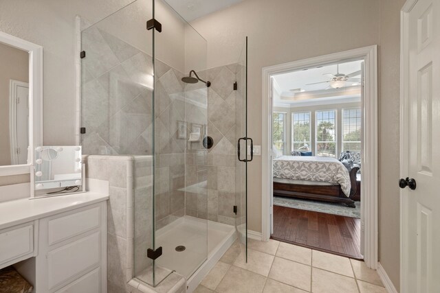 4013 Tulane St, Flower Mound, TX 75022 - ensuite bathroom with vanity, a stall shower, a ceiling fan, tile patterned floors, and baseboards