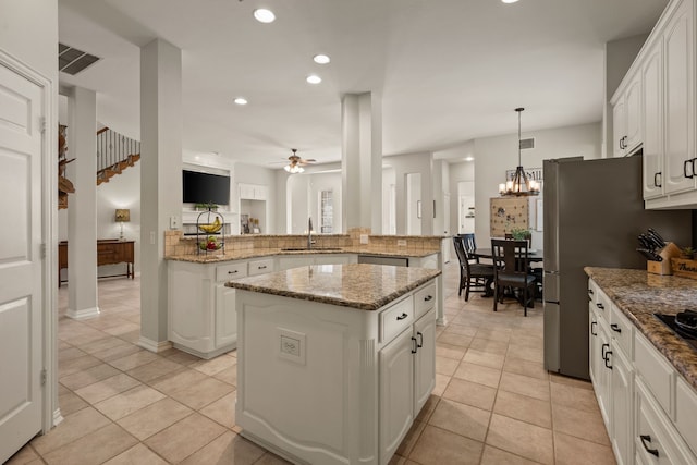 4013 Tulane St, Flower Mound, TX 75022 - kitchen with a kitchen island, ceiling fan, a peninsula, light tile patterned flooring, and recessed lighting