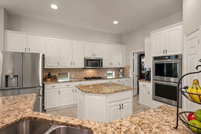 4013 Tulane St, Flower Mound, TX 75022 - kitchen featuring stainless steel appliances, light tile patterned floors, backsplash, light stone countertops, and recessed lighting