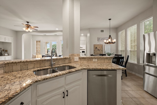4013 Tulane St, Flower Mound, TX 75022 - kitchen featuring a sink, appliances with stainless steel finishes, light stone countertops, light tile patterned floors, and a ceiling fan