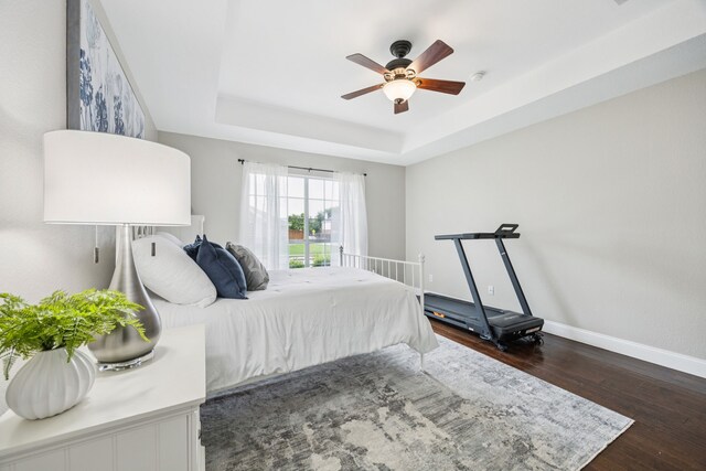 1532 Streams Way, Allen, TX 75002 - bedroom with dark wood-style flooring, baseboards, a raised ceiling, and ceiling fan