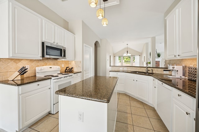 1532 Streams Way, Allen, TX 75002 - kitchen with white appliances, a sink, arched walkways, tasteful backsplash, and a peninsula