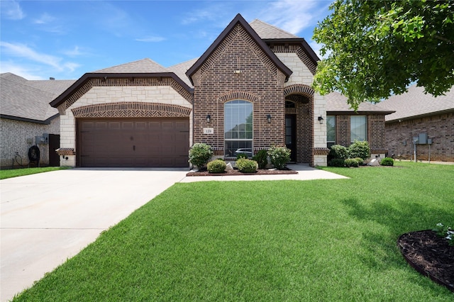 129 Colonial Dr, Joshua, TX 76058 - french country home with brick siding, a front yard, a garage, and driveway