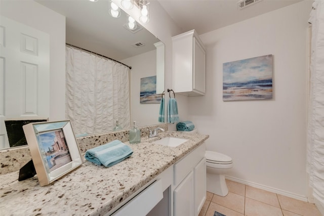 5644 Overland Dr, The Colony, TX 75056 - bathroom with vanity, toilet, baseboards, and tile patterned floors