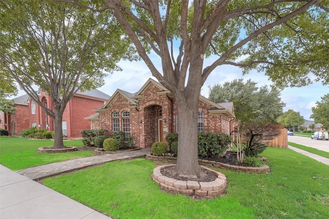 5644 Overland Dr, The Colony, TX 75056 - traditional-style home with brick siding and a front yard