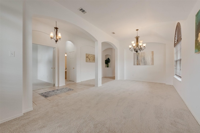 5644 Overland Dr, The Colony, TX 75056 - carpeted spare room with a chandelier, arched walkways, and tile patterned flooring