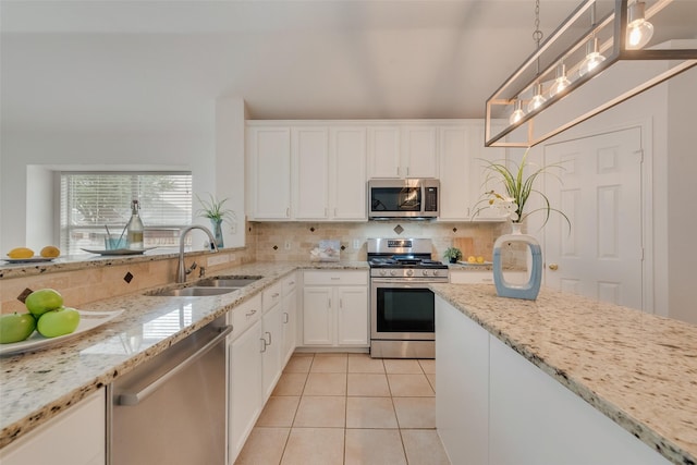 5644 Overland Dr, The Colony, TX 75056 - kitchen with appliances with stainless steel finishes, a sink, decorative backsplash, light tile patterned flooring, and white cabinetry
