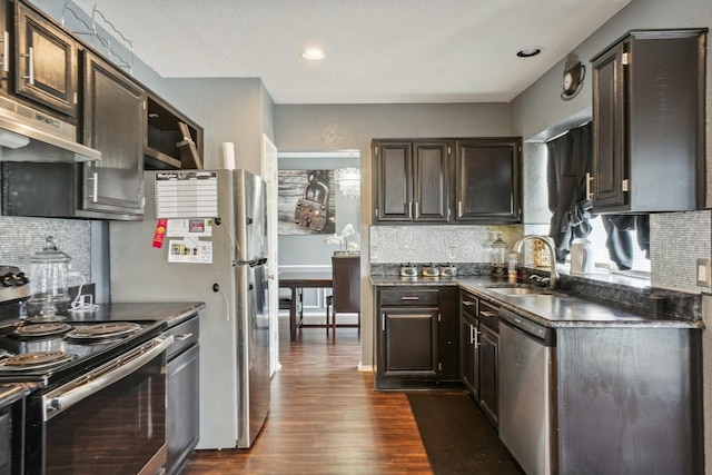 3017 Deanne Ct, Fort Worth, TX 76123 - kitchen with appliances with stainless steel finishes, dark countertops, dark wood-style floors, decorative backsplash, and recessed lighting