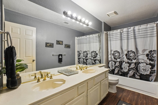 3017 Deanne Ct, Fort Worth, TX 76123 - bathroom with toilet, double vanity, wood finished floors, shower / tub combo with curtain, and a textured ceiling