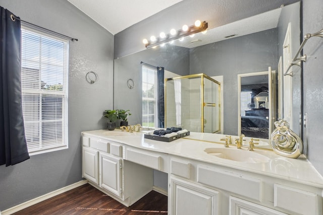 3017 Deanne Ct, Fort Worth, TX 76123 - bathroom featuring wood finished floors, a shower stall, double vanity, connected bathroom, and baseboards