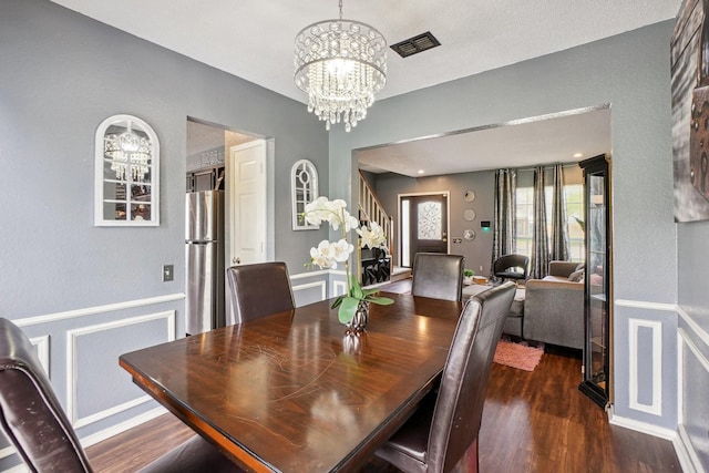 3017 Deanne Ct, Fort Worth, TX 76123 - dining room with a chandelier, wainscoting, wood finished floors, and stairs