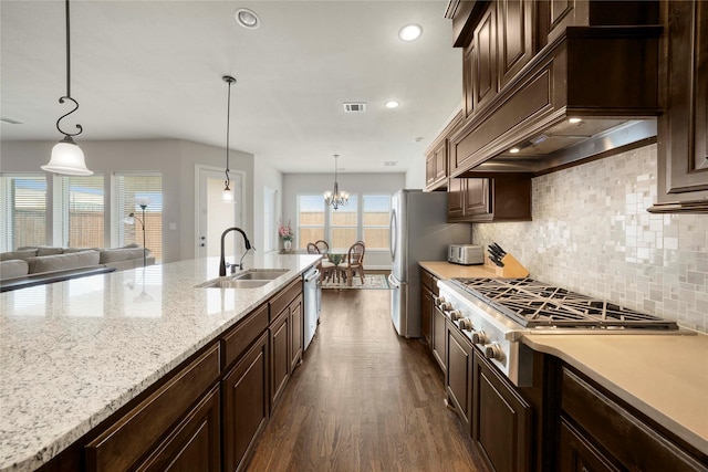8670 Soto Ln, Frisco, TX 75036 - kitchen with a sink, dark wood-style flooring, appliances with stainless steel finishes, dark brown cabinets, and recessed lighting