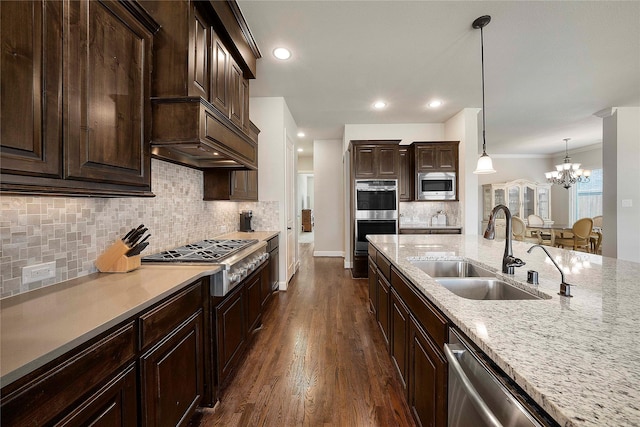 8670 Soto Ln, Frisco, TX 75036 - kitchen featuring a sink, stainless steel appliances, a chandelier, dark wood-style floors, and backsplash