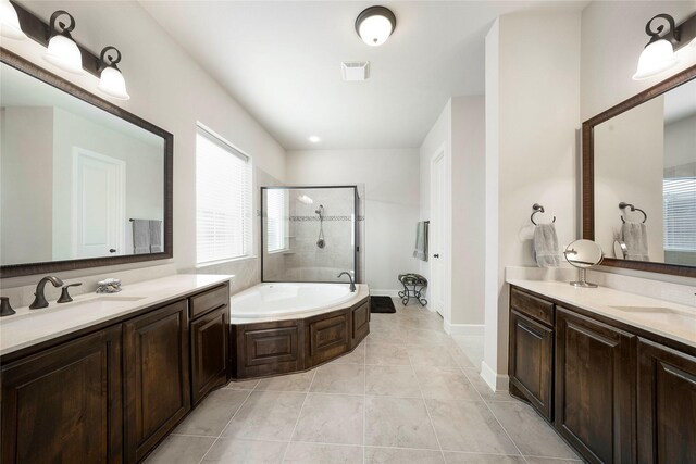 8670 Soto Ln, Frisco, TX 75036 - bathroom with a stall shower, two vanities, a bath, and tile patterned floors