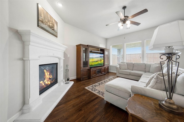 8670 Soto Ln, Frisco, TX 75036 - living room with a ceiling fan, a glass covered fireplace, baseboards, and dark wood finished floors