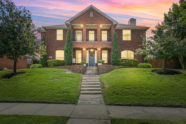 3752 Menard Dr, Carrollton, TX 75010 - view of front facade with a balcony, brick siding, and a chimney