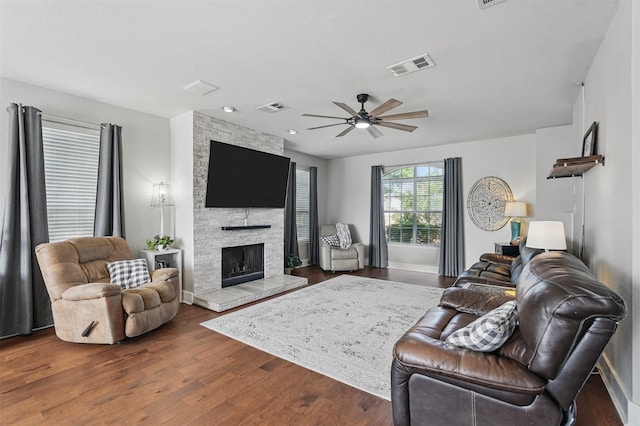 3752 Menard Dr, Carrollton, TX 75010 - living room with wood finished floors, ceiling fan, baseboards, and a fireplace