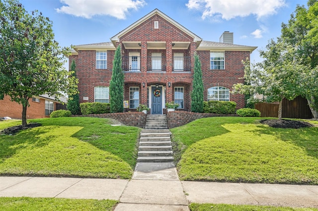 3752 Menard Dr, Carrollton, TX 75010 - colonial home featuring brick siding, a chimney, and a balcony