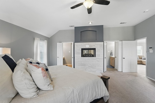 3752 Menard Dr, Carrollton, TX 75010 - carpeted bedroom with lofted ceiling, ensuite bathroom, a ceiling fan, a multi sided fireplace, and baseboards
