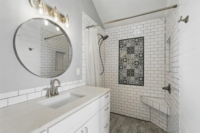 3752 Menard Dr, Carrollton, TX 75010 - bathroom with vanity, a tile shower, and wood finished floors
