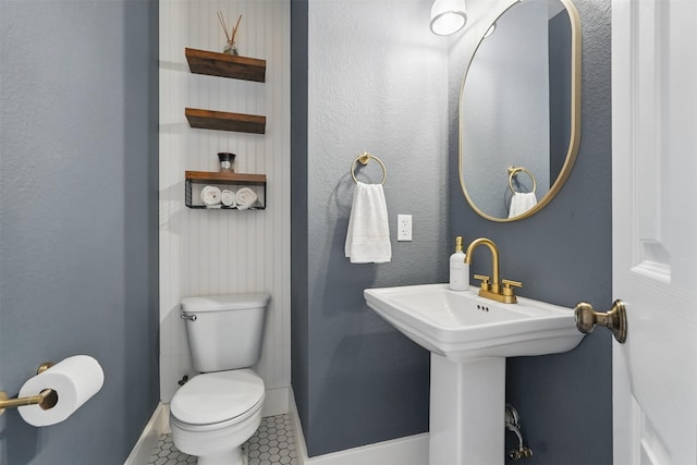 3752 Menard Dr, Carrollton, TX 75010 - bathroom with baseboards, tile patterned flooring, and toilet