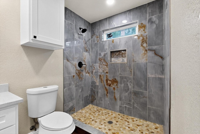 2217 36th St, Fort Worth, TX 76106 - full bathroom featuring toilet, a tile shower, and vanity