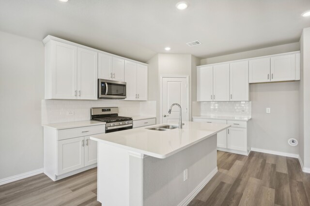301 Sierra Rdg, Lavon, TX 75166 - kitchen featuring appliances with stainless steel finishes, a sink, light wood-style floors, decorative backsplash, and recessed lighting