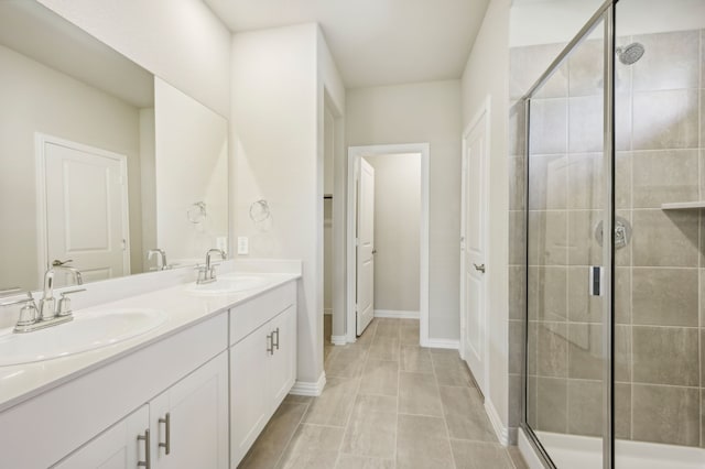 301 Sierra Rdg, Lavon, TX 75166 - bathroom featuring a shower stall, double vanity, and baseboards